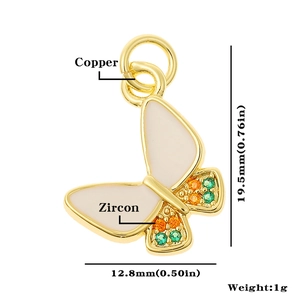 Detailed macro view of copper butterfly pendant with white enamel and colorful zircons