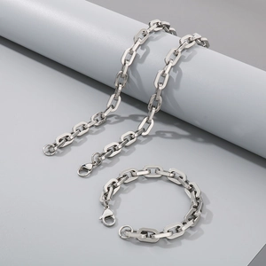 Macro shot of silver titanium steel rectangular link chain necklace and bracelet set