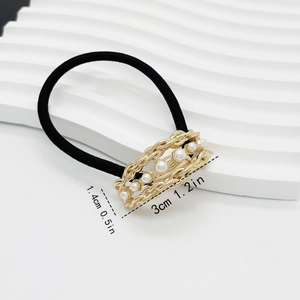 Detail of gold metal weave hair tie with pearls and size labels 3cm by 1.4cm