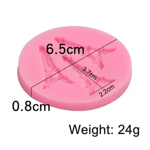 Pink silicone mold for fondant featuring Eiffel Tower patterns with 6.5cm diameter size