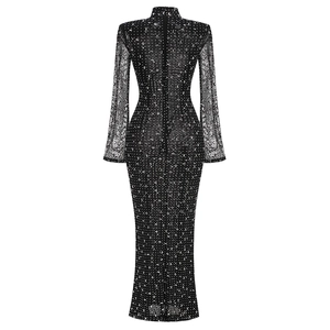 Detail of elegant black mesh dress featuring shimmering silver sequins and back zipper