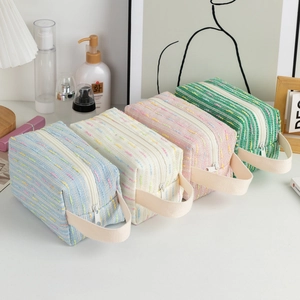Set of four colorful tweed cosmetic bags with zipper closure and side handles for travel