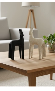 Detailed macro view of minimalist matte resin horse statues in black and beige finishes
