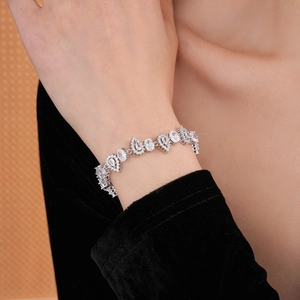 Close-up of elegant silver bracelet with pear-shaped zircon stones on woman's wrist