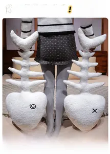 Detailed view of plush white fish bone pillows with soft texture held by a person