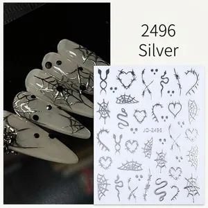 Detailed view of silver 3D Halloween nail stickers with spider web and heart patterns