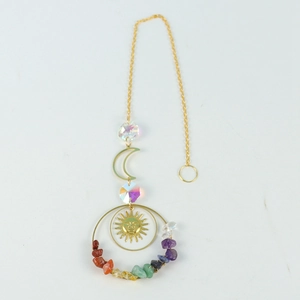 Detail of golden sun and moon suncatcher with colorful crystal stones and glass beads