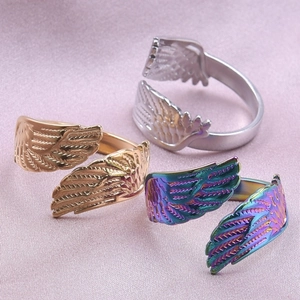 Minimalist stainless steel wing ring in silver, gold, and rainbow colors with feather details