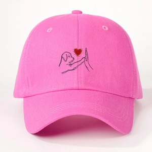 Detail of rose pink baseball cap featuring a creative dog and hand high-five heart print