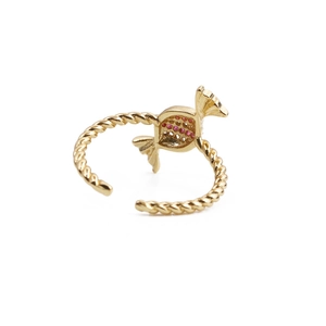 Detail of gold twisted band ring with red zircon stone in candy shape and open design