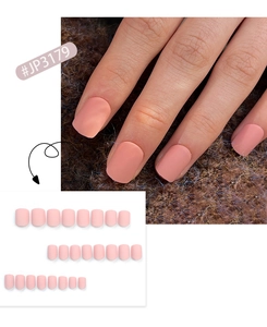 Detailed view of matte light pink short press-on nails set on brown plush fabric background