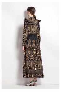 Detail view of the back of a vintage V-neck maxi dress with gold baroque print patterns