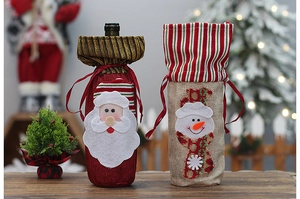 Detail of Santa and Snowman linen wine bottle bags with festive holiday decorations