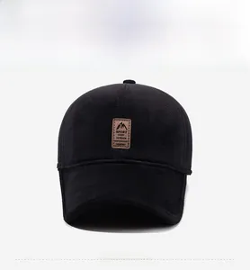 Detail view of winter baseball cap with ear flaps and embossed brown leather Sport patch