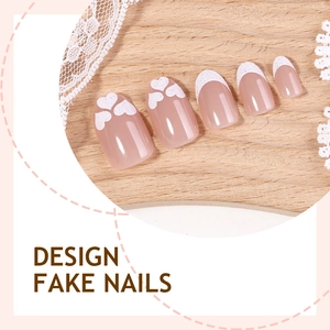 French tip press-on nails with heart patterns and nude pink base on oval shape