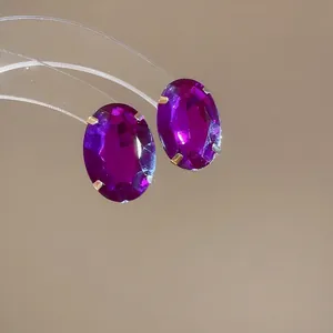 Elegant vintage geometric oval purple gemstone earrings set in a luxe four-prong mount