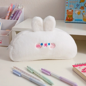 Detail of soft white plush pencil case with cute 3D bunny ears and embroidered face