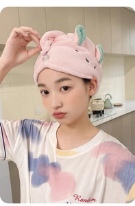 Detailed view of absorbent pink microfiber hair towel with cute green rabbit ears