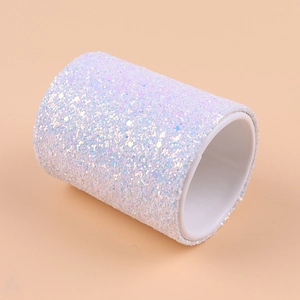 Close-up of cylindrical makeup brush holder with white iridescent glitter finish