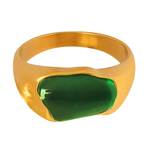 Minimalist wide gold ring with an irregular emerald green resin inlay on a white background