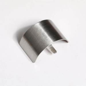 Macro shot of silver brushed metal ponytail hook accessory with minimalist curved design