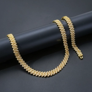 Detailed close-up of 14mm gold Cuban link necklace and bracelet set with micro-pave zircons