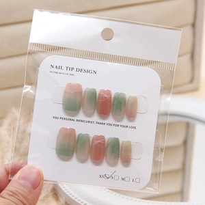 Pink and green cat eye press-on nails set with gradient design and artistic line patterns