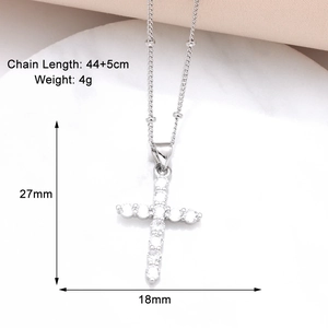 Macro shot showing dimensions of silver cross pendant necklace with zircon detailing