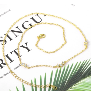 Minimalist 18k gold plated necklace with micro-pave white cubic zirconia on a fashion magazine