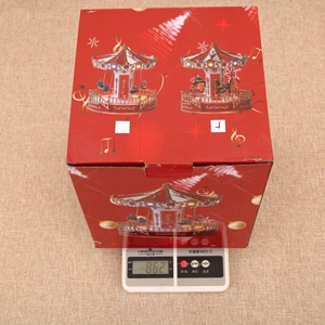 Luminous carousel music box gift set shown on digital scale weighing 862 grams