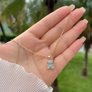 Detail of 18K gold plated necklace featuring a cute teddy bear pendant with blue zircon stones