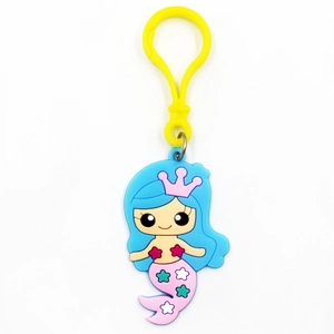 Detail of cartoon mermaid keychain with pink crown and colorful star patterns on tail