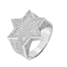 Macro di un anello hip hop in argento con micro-pavé di zirconi su una grande stella