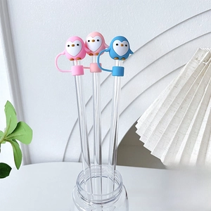 Close-up of cute penguin silicone straw toppers in pink and blue for 10mm drinking straws
