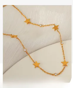 Detail of gold star necklace with alternating matte stars and white round gemstones