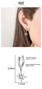 Detail view of silver huggie earrings with light blue star pendant and dimensions
