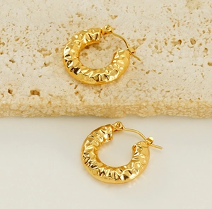 Detailed view of 18K gold plated hoop earrings with hammered lava texture