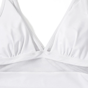 Close-up of white deep V-neck swimsuit with mesh panels and pleated chest detail