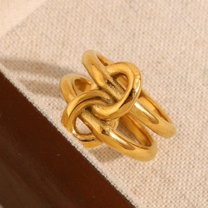 Macro shot of 18K gold plated knotted multi-layer ring on rustic burlap background