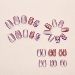 Detailed view of lavender cat eye press-on nails with glitter and rhinestone accents
