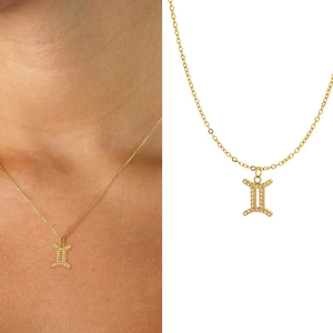 Detailed view of Gemini zodiac pendant in gold finish with white zircon micro-inlay