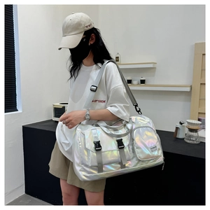 Fashionable silver holographic waterproof fitness bag shown in use by a stylish model