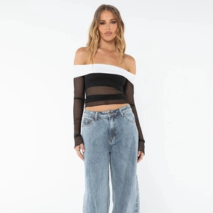 Close-up of contrast mesh long sleeves on a black off-shoulder slim fit top