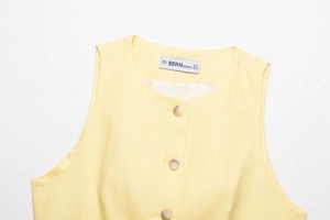 Close-up of linen tank top collar with buttons and size tag in yellow color