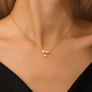 Close-up of S925 silver star pendant necklace with white pearls on a model's neck
