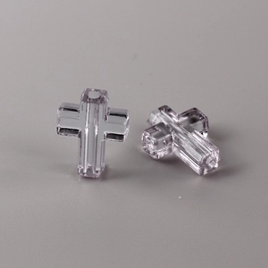 Macro shot of transparent lavender cross beads with faceted glass texture for DIY jewelry