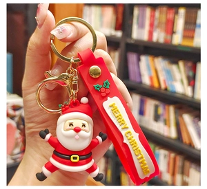 Detail of Santa Claus PVC keychain with red Merry Christmas strap and gold lobster clasp