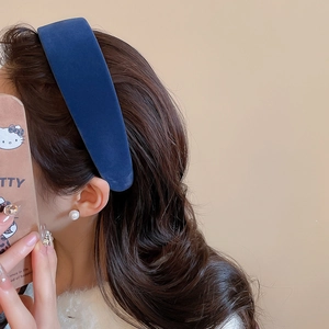 Detail of high-crown dark blue velvet headband showing soft texture and elegant vintage style