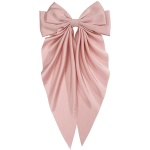 Close-up of a large pink satin bow hair clip with elegant long hanging ribbons