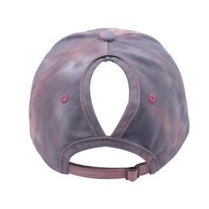Close-up of ponytail hole and adjustable metal buckle on tie-dye baseball cap